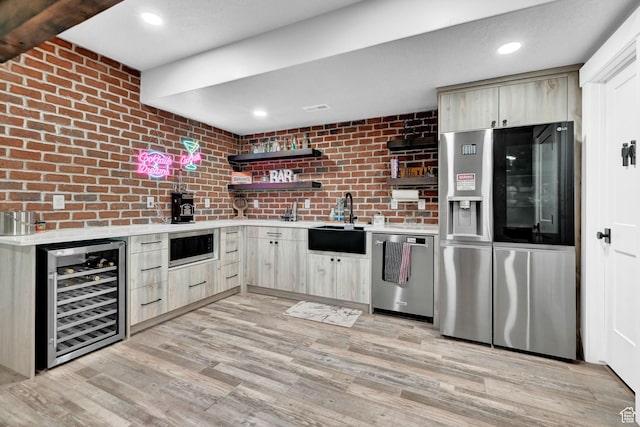 2673 S 4950 W, Taylor, UT 84401 - kitchen featuring wine cooler, stainless steel appliances, light brown cabinetry, light countertops, and light wood finished floors