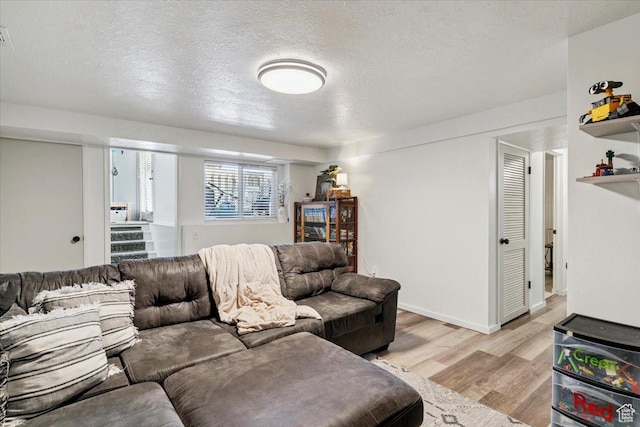 5659 Woodshire Ct, South Ogden, UT 84403 - living room featuring light wood-type flooring and a textured ceiling