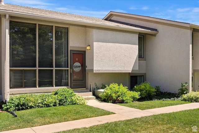 5659 Woodshire Ct, South Ogden, UT 84403 - view of front facade featuring stucco siding and a front lawn