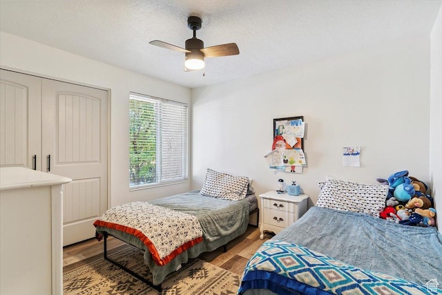 5659 Woodshire Ct, South Ogden, UT 84403 - bedroom featuring light wood-style flooring, a textured ceiling, and ceiling fan