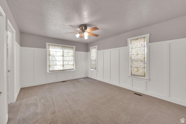 797 E 10 S, American Fork, UT 84003 - unfurnished bedroom featuring a decorative wall, a textured ceiling, carpet flooring, wainscoting, and ceiling fan