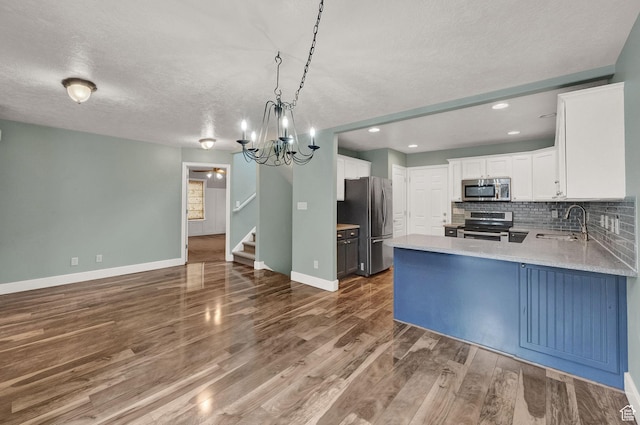 797 E 10 S, American Fork, UT 84003 - kitchen with stainless steel appliances, tasteful backsplash, a peninsula, dark wood-style flooring, and white cabinets