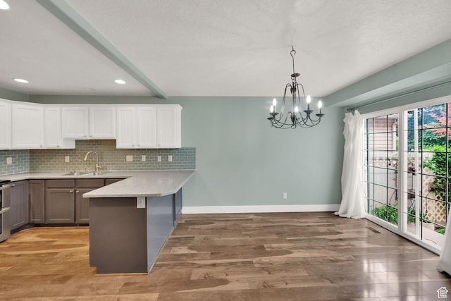 797 E 10 S, American Fork, UT 84003 - kitchen featuring a peninsula, backsplash, light wood finished floors, white cabinets, and recessed lighting