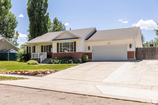1104 E 220 N, Heber City, UT 84032 - ranch-style home with brick siding, a garage, driveway, and a porch