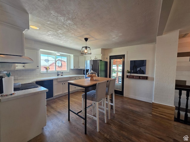 1525 N 1250 W, Provo, UT 84604 - kitchen with fridge with ice dispenser, dark wood-style flooring, tasteful backsplash, white cabinets, and light countertops