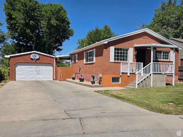 1525 N 1250 W, Provo, UT 84604 - view of front facade with driveway, a front yard, brick siding, and an outbuilding