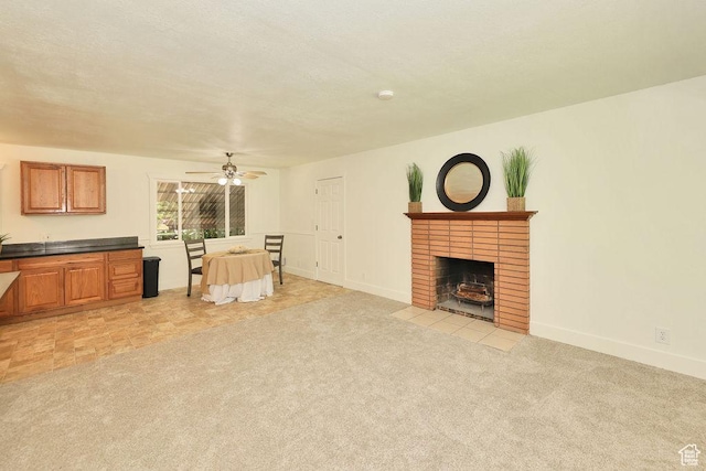 3165 S Jackson Ave, Ogden, UT 84403 - living room with ceiling fan, light colored carpet, and a brick fireplace