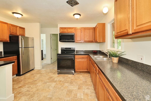 3165 S Jackson Ave, Ogden, UT 84403 - kitchen with electric range oven, freestanding refrigerator, dark countertops, and brown cabinetry