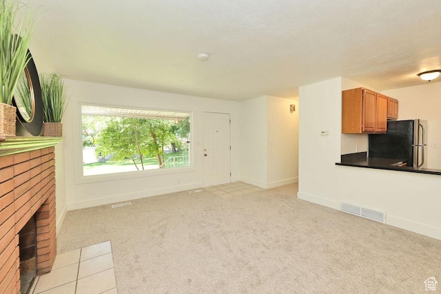 3165 S Jackson Ave, Ogden, UT 84403 - unfurnished living room featuring light colored carpet and a fireplace