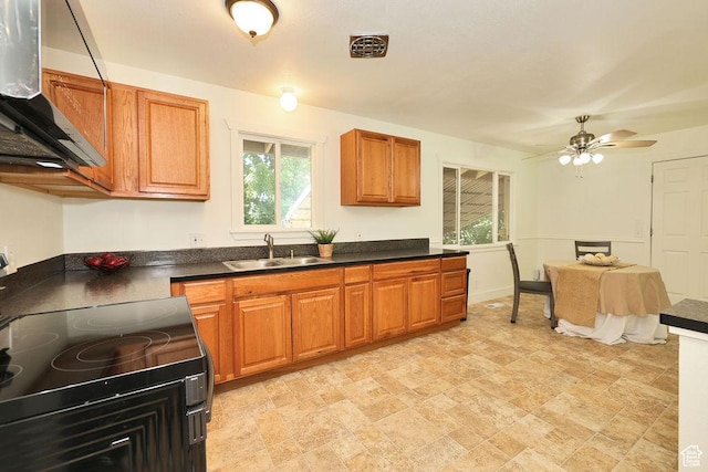 3165 S Jackson Ave, Ogden, UT 84403 - kitchen with range with electric stovetop, range hood, dark countertops, brown cabinetry, and a ceiling fan