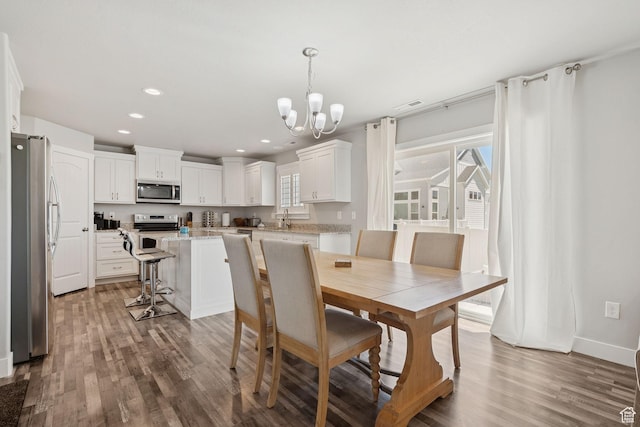 9634 N Red Bridge Rd, Eagle Mountain, UT 84005 - dining space with a chandelier, wood finished floors, and recessed lighting