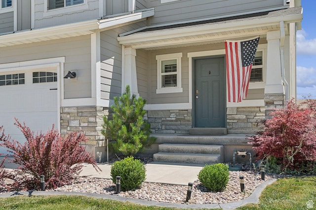 9634 N Red Bridge Rd, Eagle Mountain, UT 84005 - doorway to property with stone siding, covered porch, and an attached garage