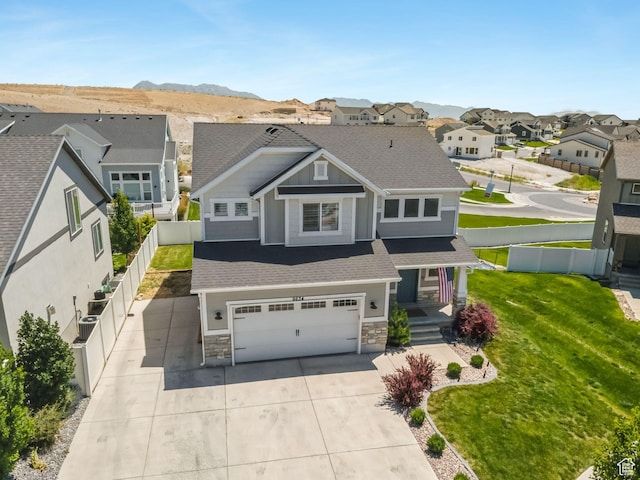 9634 N Red Bridge Rd, Eagle Mountain, UT 84005 - view of front of home with a garage, a residential view, stone siding, driveway, and covered porch