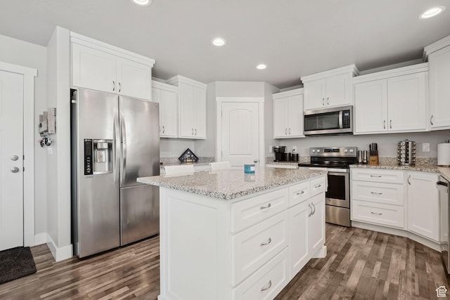 9634 N Red Bridge Rd, Eagle Mountain, UT 84005 - kitchen featuring appliances with stainless steel finishes, a kitchen island, dark wood-style flooring, white cabinetry, and recessed lighting