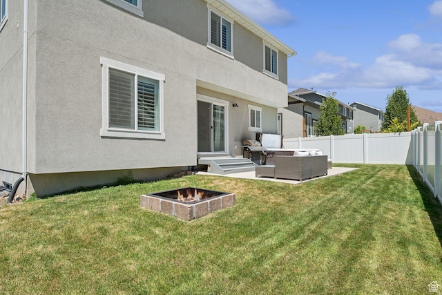 9634 N Red Bridge Rd, Eagle Mountain, UT 84005 - rear view of house featuring an outdoor living space with a fire pit, a fenced backyard, stucco siding, a patio, and a residential view