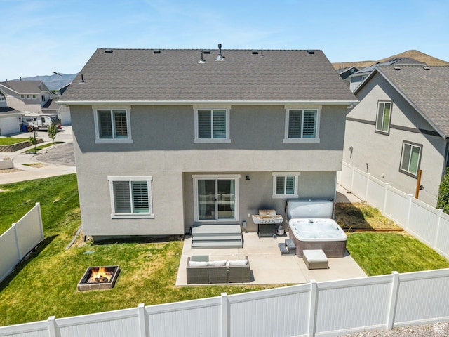 9634 N Red Bridge Rd, Eagle Mountain, UT 84005 - back of property featuring an outdoor living space with a fire pit, a fenced backyard, a patio area, and a hot tub