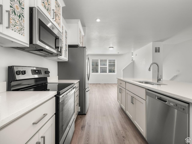 475 S 900 W, American Fork, UT 84003 - kitchen featuring appliances with stainless steel finishes, white cabinets, wood finished floors, light countertops, and recessed lighting
