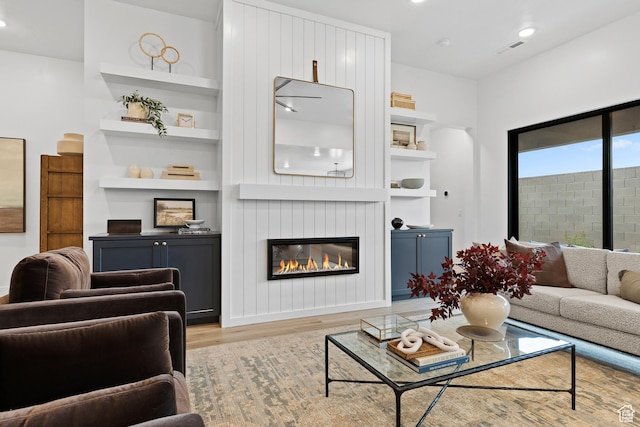 3353 W Bonita Unit 23, Hurricane, UT 84737 - living room with wood finished floors, built in shelves, a glass covered fireplace, and recessed lighting