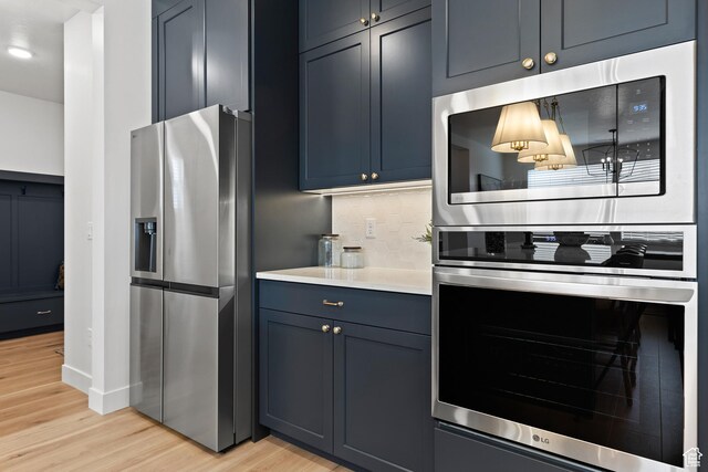 3353 W Bonita Unit 23, Hurricane, UT 84737 - kitchen with appliances with stainless steel finishes, light wood-style floors, tasteful backsplash, light countertops, and recessed lighting