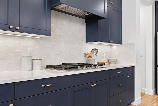 3353 W Bonita Unit 23, Hurricane, UT 84737 - kitchen with extractor fan, blue cabinetry, stainless steel gas cooktop, backsplash, and wood finished floors