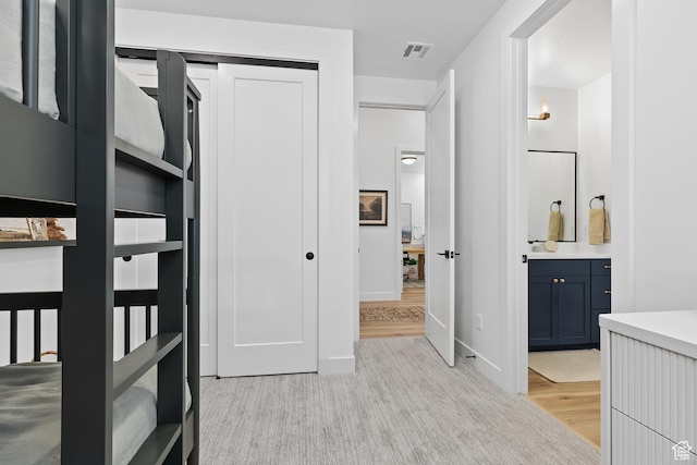 3353 W Bonita Unit 23, Hurricane, UT 84737 - unfurnished bedroom featuring ensuite bathroom, light wood-style flooring, and a closet