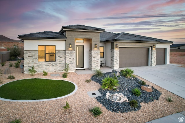 3353 W Bonita Unit 23, Hurricane, UT 84737 - prairie-style house featuring stone siding, an attached garage, stucco siding, and concrete driveway