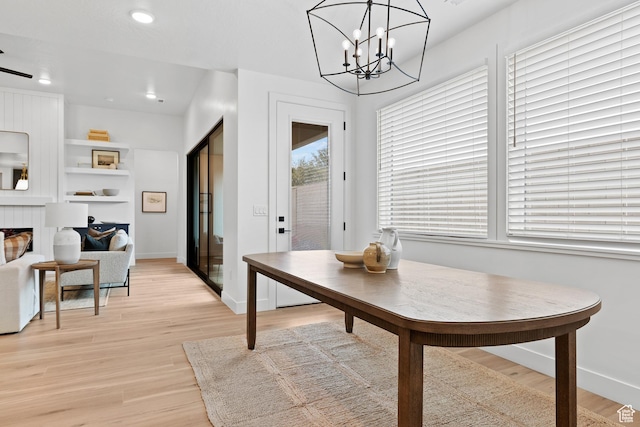 3353 W Bonita Unit 23, Hurricane, UT 84737 - dining space with light wood finished floors, a tile fireplace, recessed lighting, and a chandelier