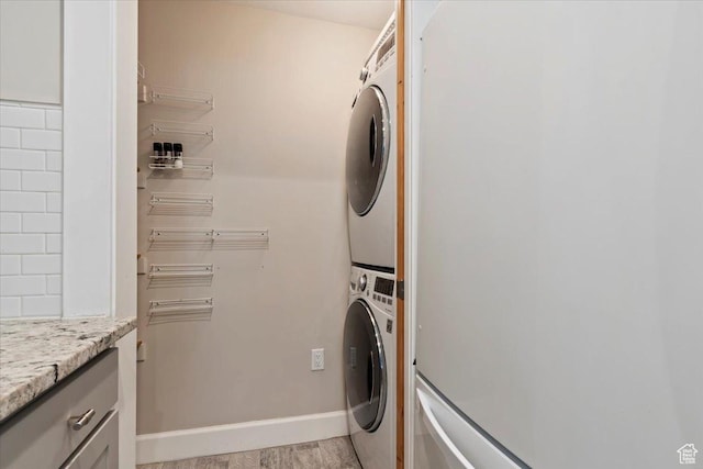 6641 N 2200 W Unit A107, Park City, UT 84098 - laundry room with estacked washer and dryer, cabinet space, and light wood-style floors