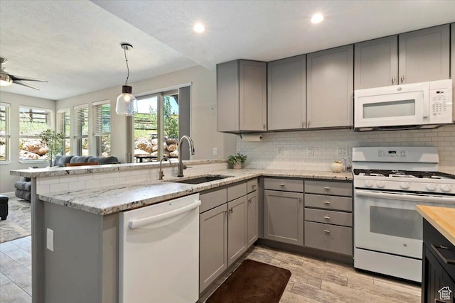 6641 N 2200 W Unit A107, Park City, UT 84098 - kitchen with white appliances, gray cabinets, a peninsula, backsplash, and recessed lighting