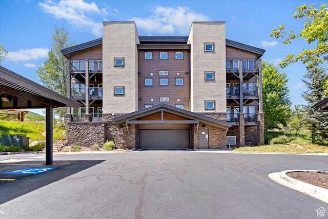 6641 N 2200 W Unit A107, Park City, UT 84098 - view of apartment building / complex featuring a garage