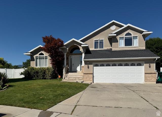 421 S 755 E, Layton, UT 84041 - craftsman-style home featuring stucco siding, an attached garage, driveway, and brick siding