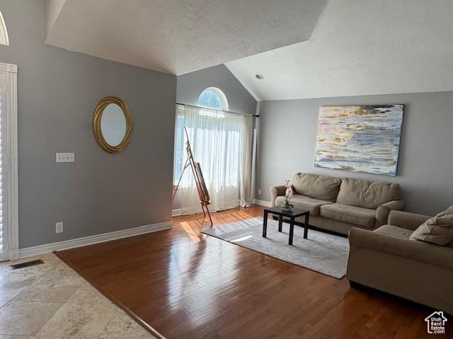 421 S 755 E, Layton, UT 84041 - living area with vaulted ceiling, a textured ceiling, and wood finished floors