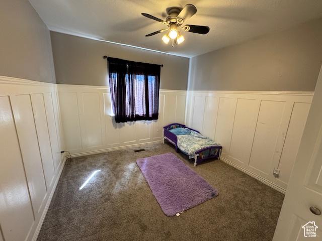 421 S 755 E, Layton, UT 84041 - unfurnished bedroom featuring a decorative wall, carpet floors, a wainscoted wall, and a ceiling fan