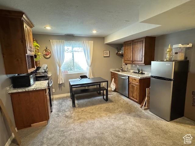 421 S 755 E, Layton, UT 84041 - kitchen featuring stainless steel appliances, light colored carpet, light countertops, brown cabinetry, and a textured ceiling