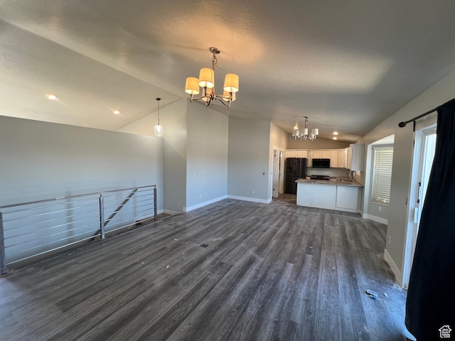 362 W 1800 S, Clearfield, UT 84015 - unfurnished living room featuring lofted ceiling, a chandelier, dark wood-style flooring, a textured ceiling, and recessed lighting