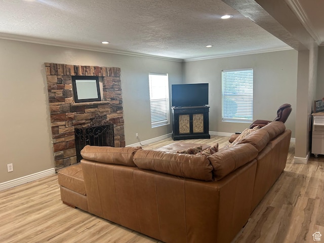 2537 S Taylor Ave E, Ogden, UT 84401 - living area featuring a fireplace, crown molding, light wood-style flooring, a textured ceiling, and recessed lighting