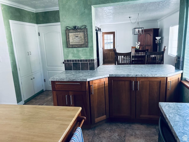 2537 S Taylor Ave E, Ogden, UT 84401 - kitchen featuring a textured ceiling, light countertops, and ornamental molding
