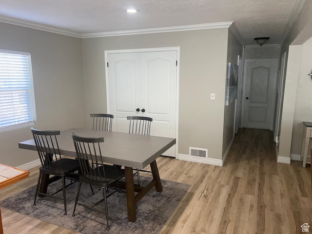 2537 S Taylor Ave E, Ogden, UT 84401 - dining area with light wood-type flooring and crown molding