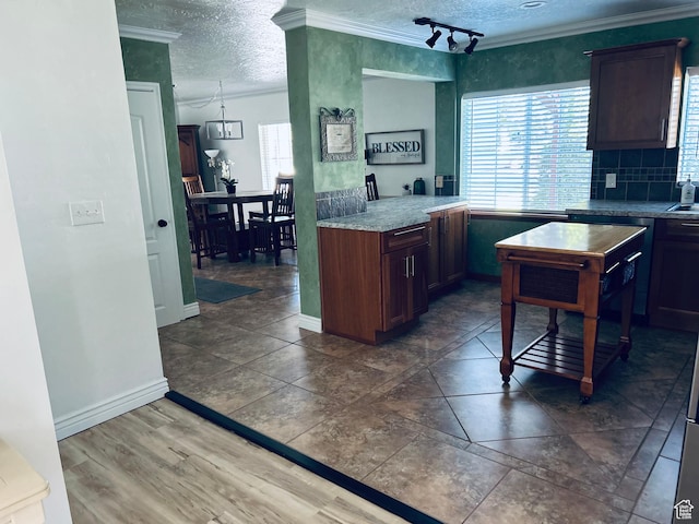 2537 S Taylor Ave E, Ogden, UT 84401 - kitchen with ornamental molding, a textured ceiling, and backsplash