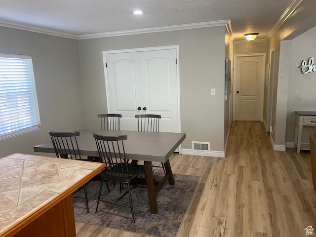 2537 S Taylor Ave E, Ogden, UT 84401 - dining space with light wood-style floors and crown molding
