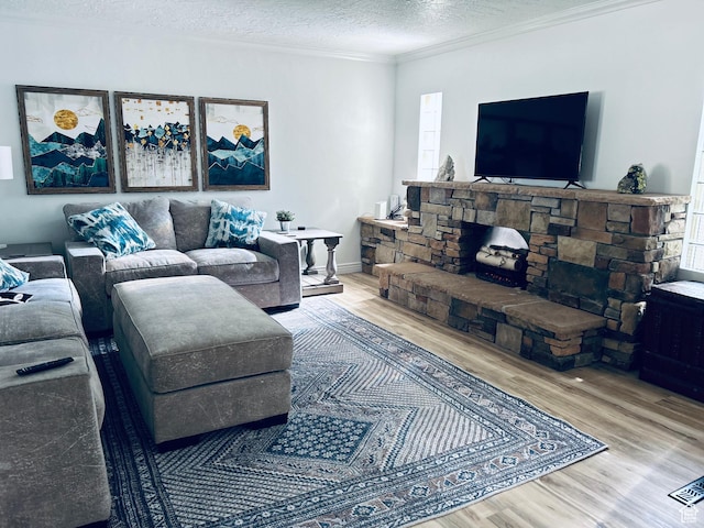 2537 S Taylor Ave E, Ogden, UT 84401 - living room featuring wood finished floors, healthy amount of natural light, ornamental molding, and a textured ceiling