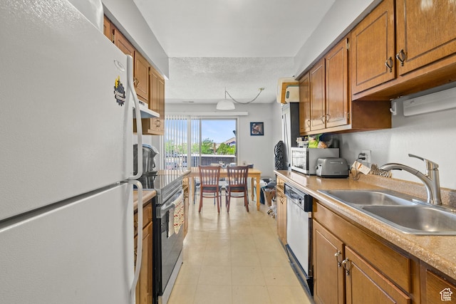 290 N 500 W Unit 210, Bountiful, UT 84010 - kitchen with freestanding refrigerator, dishwashing machine, stainless steel electric range, brown cabinets, and light countertops