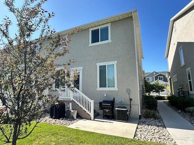 214 W Whitewater Dr, Vineyard, UT 84059 - rear view of house with stucco siding and a patio area