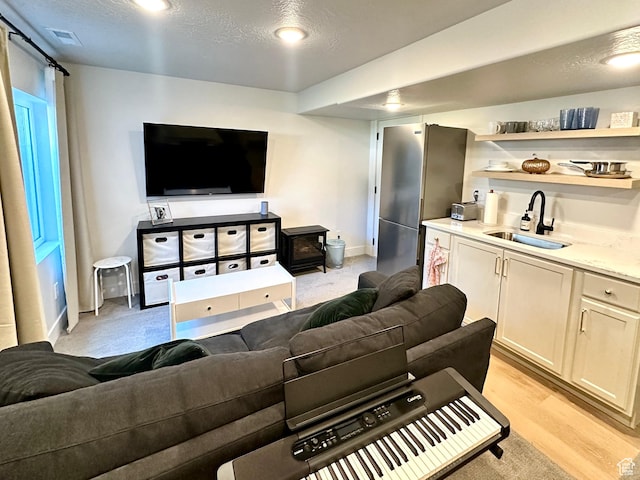 214 W Whitewater Dr, Vineyard, UT 84059 - living room with a textured ceiling and light wood-style floors