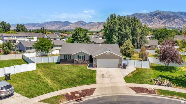 985 W 2675 S, Nibley, UT 84321 - view of front of house with driveway, a mountain view, a residential view, a garage, and a fenced backyard