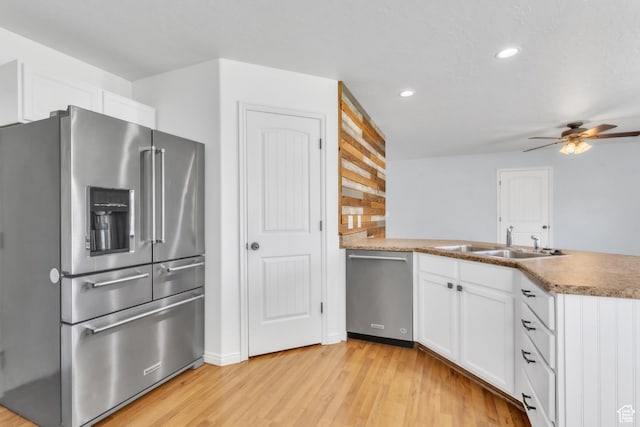 985 W 2675 S, Nibley, UT 84321 - kitchen with appliances with stainless steel finishes, a peninsula, recessed lighting, a ceiling fan, and light wood-style flooring
