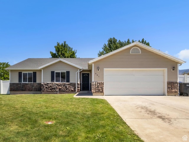 985 W 2675 S, Nibley, UT 84321 - ranch-style home featuring driveway, an attached garage, a front lawn, and stone siding