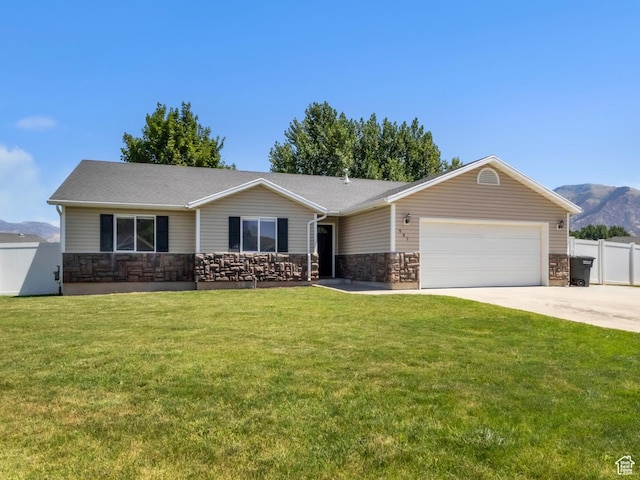 985 W 2675 S, Nibley, UT 84321 - ranch-style home featuring stone siding, a garage, driveway, and a mountain view