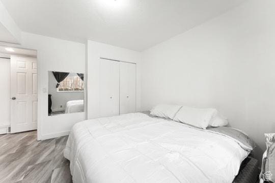 1196 E Waterside Cv S Unit 11, Cottonwood Heights, UT 84047 - bedroom featuring wood finished floors and a closet