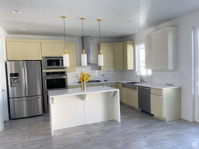 63 E Rose Way, Vineyard, UT 84059 - kitchen with stainless steel appliances, wall chimney exhaust hood, a kitchen island, light countertops, and recessed lighting